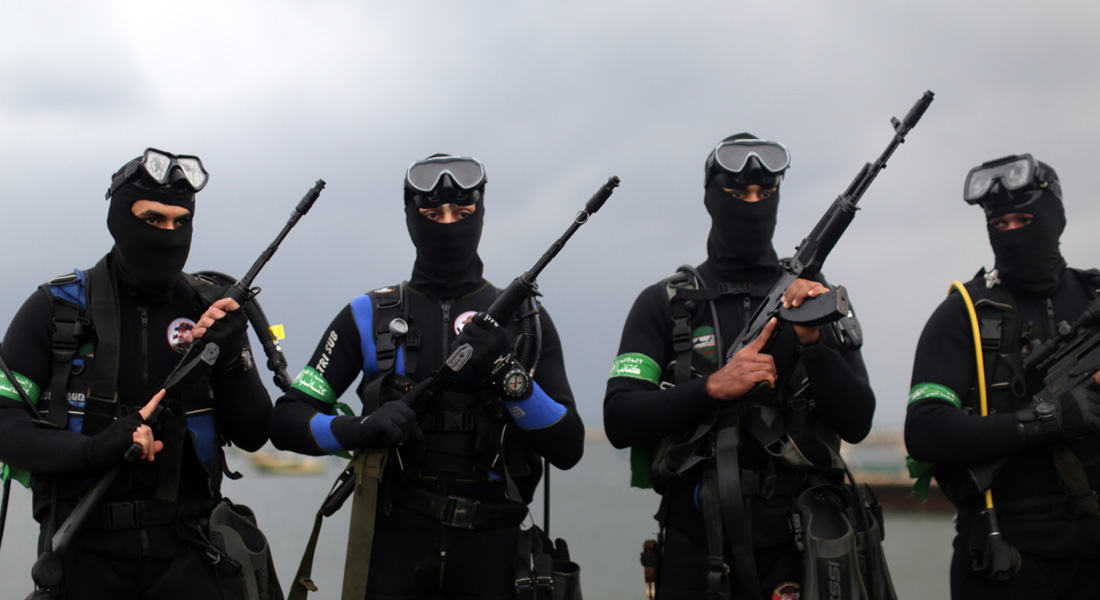 Palestinian Frogmen of the Ezzedine al-Qassam Brigades, Hamas's armed wing, pose in wetsuits as they take part in a military parade marking the 27th anniversary of the Islamist movements creation on December 14, 2014 in Gaza City. AFP PHOTO / MAHMUD HAMS (Photo credit should read MAHMUD HAMS/AFP/Getty Images)